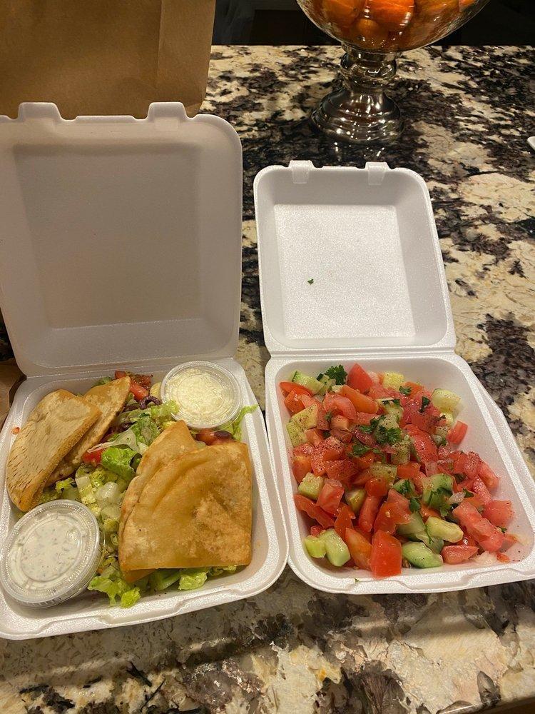 Greek Salad · Romaine hearts lettuce with tomatoes, cucumbers, lemon, olive oil and garlic topped with feta cheese and kalamata olives. Served with pocket pita bread.