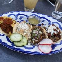 Carne Asada · Marinated grilled arrachera served over onions sautéed in soy & lime, topped with a Oaxaca s...