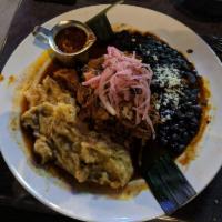 Cochinita Pibil · The Queen's acclaimed pork is marinated in sour orange and achiote paste, wrapped in a banan...