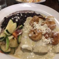 The Queen Enchiladas · A rich blend of Oaxaca, cotija and goat cheese mixed with sauteed spinach, shallots and garl...