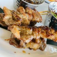 Moo Ping · Grilled pork, marinated Thai special seasoning and coconut milk served with Thai hot sauce.