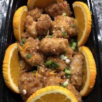 Orange Chicken · Crispy batter chicken tossed in fresh Orange sauce topped with Green onions, Sesame seeds, a...