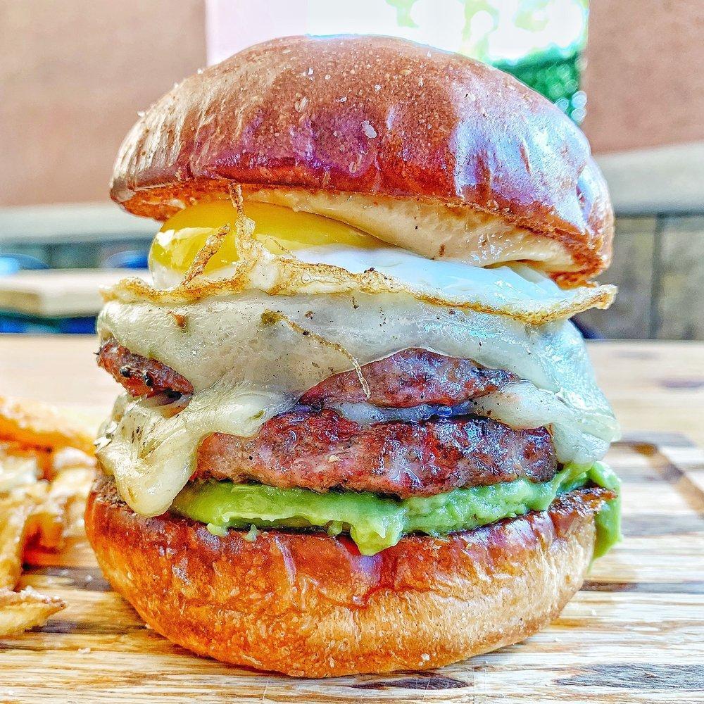 The Original 50/50 Burger Meal · Our signature 50/50 beef and bacon blend, pepper jack cheese, avocado, sunny side up egg and chipotle mayo on a brioche bun.