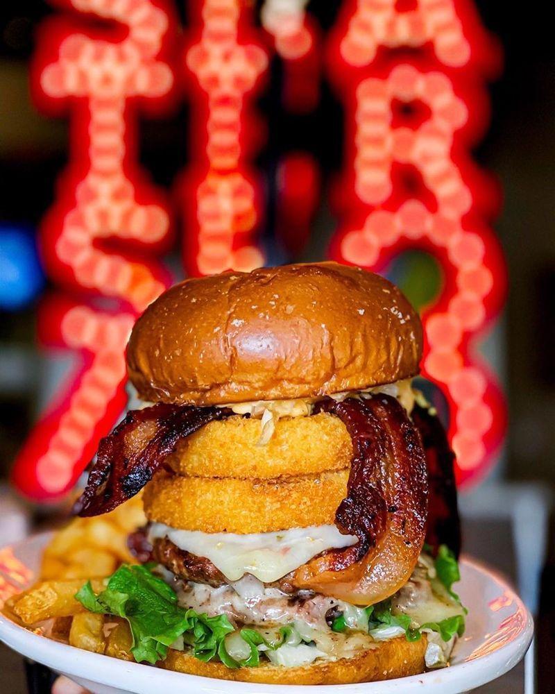 Lone Star Smoke Burger Meal · Black Canyon Angus beef topped with smoked bacon, cheddar cheese, (UNAVAILABLE)crispy onion rings, pickles, smoky barbecue sauce and garlic aioli on a brioche bun.