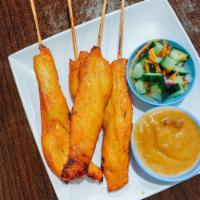 Chicken Satay · Skewered meat with a sauce.