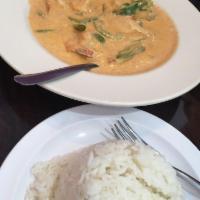 Panang Curry · Thai panang curry with coconut milk, peanut sauce, bell pepper, and basil served with steame...