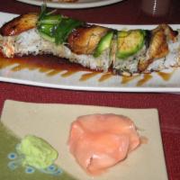 Dragon Roll · California roll topped with eel, avocado, eel sauce, and sesame seeds.