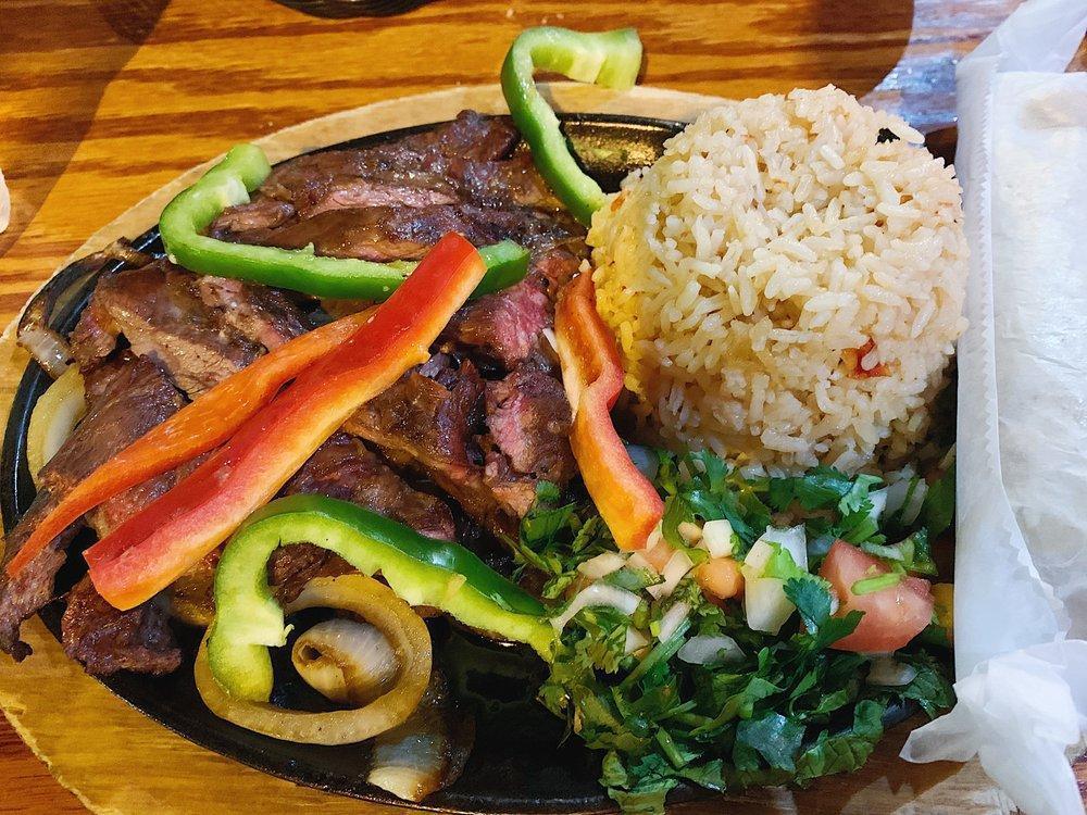 Fajitas · Sizzling strips of charbroiled chicken or steak with onions, and peppers. Served with guacamole and sour cream.