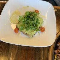 Avocado Toast · Mashed avocado on toasted multi-grain bread, seasoned grilled tomatoes and arugula. Recommen...
