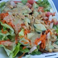 Thai Chicken Salad · Romaine lettuce, grilled chicken breast, red cabbage, carrots, tomatoes & peanuts with house...