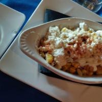 Esquites · Served grilled corn sauteed with salt, lime, red pepper and epazote, topped with sour cream,...