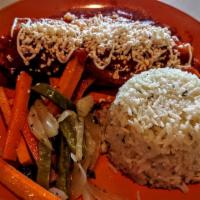 Chile Relleno · Chile poblano stuffed with queso fresco topped with home made tomato sauce. Served with hous...
