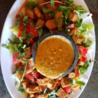 Thai Salad · Marinated chicken or tofu over a bed of romaine lettuce with carrots, sunflower sprouts, tom...