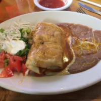Al Pastor Chimichanga · Chimichanga filled with seasoned pork served with lettuce, cheese, sour cream, and tomatoes.