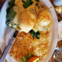 Country Style Eggs Benedict · Ham steak on an open faced homemade biscuit - topped with country style gravy served with ha...