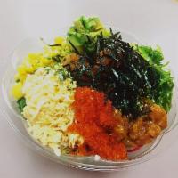 Yuzu Salmon Poke Bowl · Sushi rice, salmon with onion, scallion, mango, seaweed salad, lettuce, kale, and red radish...