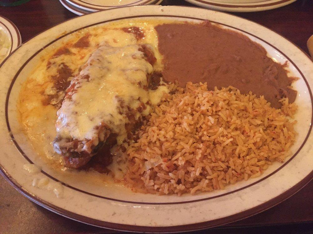 Chile Rellenos · 1 poblano pepper stuffed with seasoned ground beef, then covered in spicy ranchero cance and Monterrey lack cheese. Served with Spanish rice, refried beans, and crispy taco.