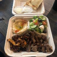 Meat Plate Combo · Gyro and chicken shawarma served with Greek salad, hummus, and pita bread.