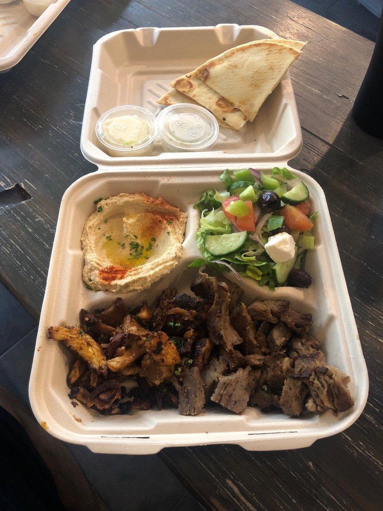 Meat Plate Combo · Gyro and chicken shawarma served with Greek salad, hummus, and pita bread.