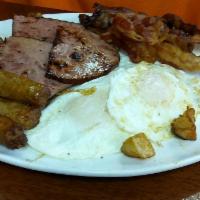 Granite Street Benedict · 2 poached eggs and corned beef hash on an English muffin. Served with home fries and creamy ...