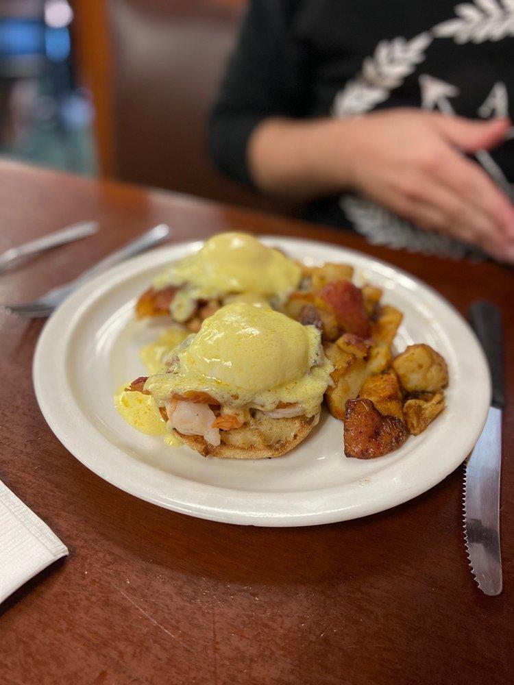 Shrimp and Bacon Benedict · 2 poached eggs on grilled shrimp and bacon and English muffin. Served with home fries and creamy homemade Hollandaise sauce.