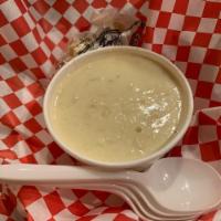 Clam Chowder · Bowl of Creamy New England Clam Chowder served with Oyster Crackers.