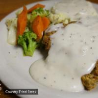 Country Fried Steak · Fried beef cutlet topped with country cream gravy.