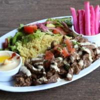 Beef Shawerma Plate · Beef shawerma served over rice pilaf, side salad, pickles, tahini & one side pick.