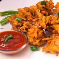 6 Pieces Vegetable Pakoras · Seasoned vegetables dipped in homemade garbanzo batter sauce and deep fried.