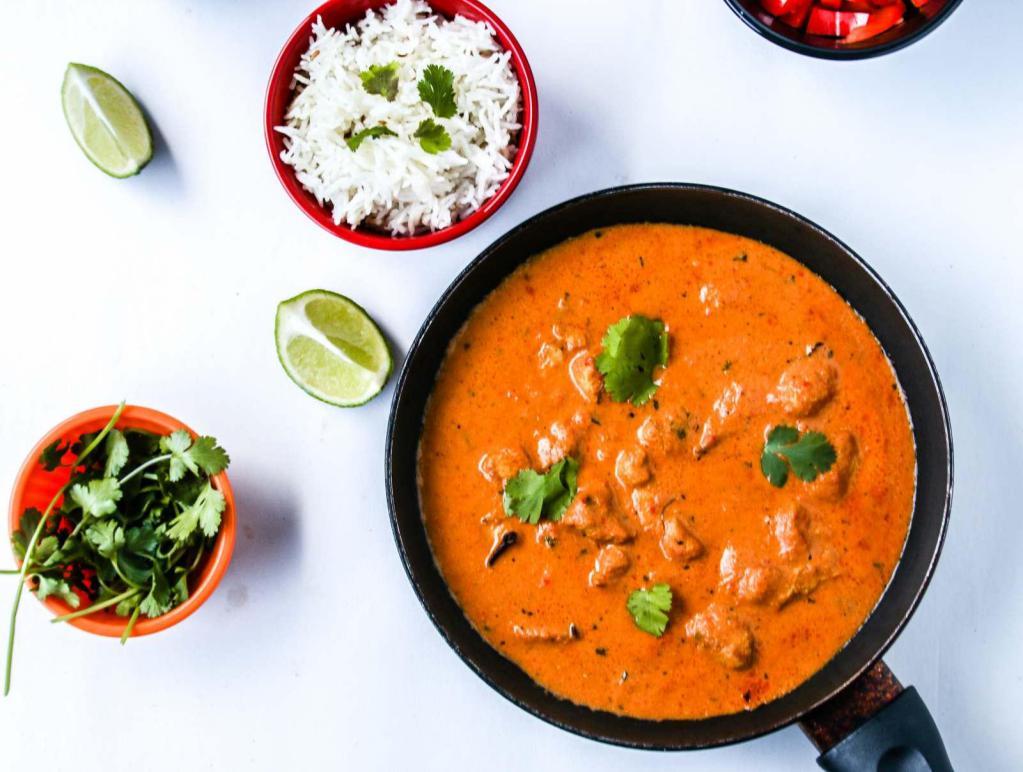 Butter Chicken · Grilled chicken marinated with yogurt and spices cooked in a creamy curry sauce.