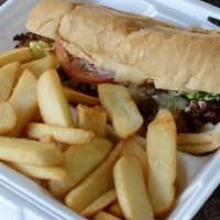 Steak and Cheese Sandwich · Served with lettuce, tomatoes, onion and french fries.