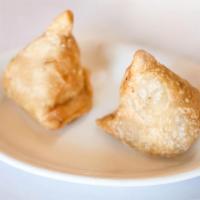 2 Piece Vegetable Samosa · Crispy pastry stuffed with mildly spiced potatoes and peas.