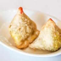 2 Piece Meat Samosa · Crispy pasty stuffed with mildly spiced ground lamb and peas.