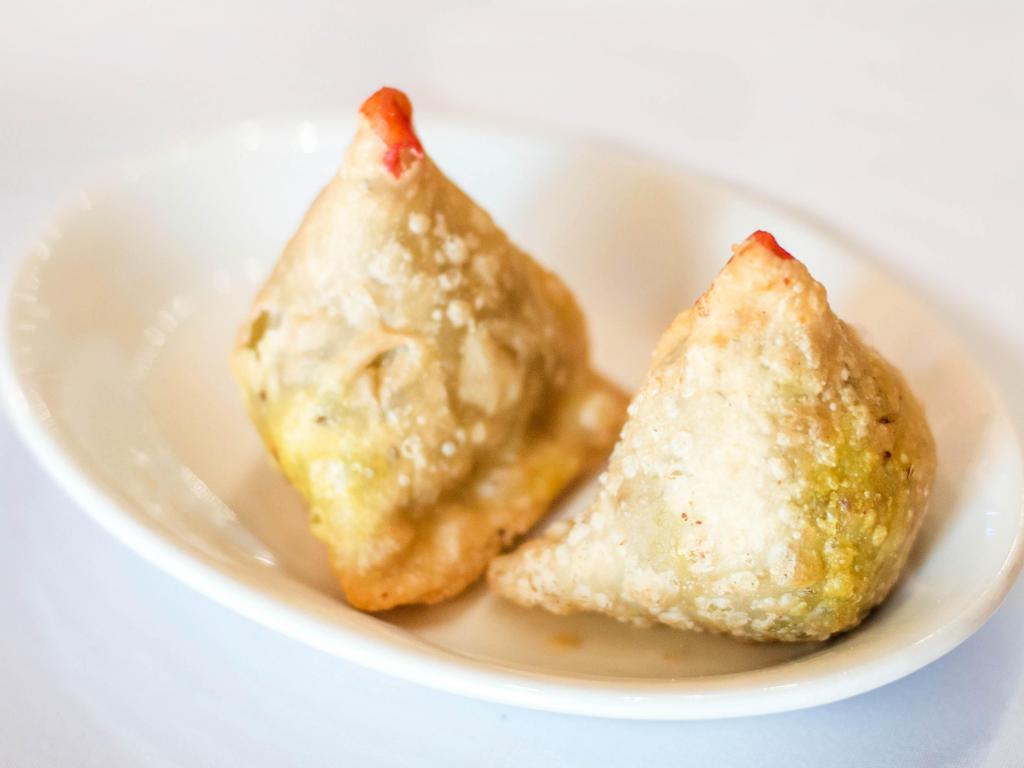 2 Piece Meat Samosa · Crispy pasty stuffed with mildly spiced ground lamb and peas.