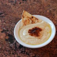 Hummus · Chickpeas and tahini dip drizzled with olive oil and paprika - served with naan 