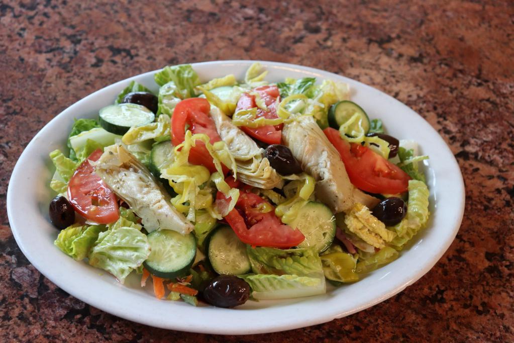 House Salad · This salad has been uniquely paired with heart of romaine, artichoke hearts, pepproncinis, tomatoes, cucumbers, and olives served with our house dressing of olive oil and red wine vinegar.