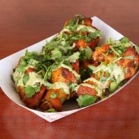 Tandoori Wings · Yogurt based chicken wings marinated with tandoori flavors and spices, topped with fresh cil...