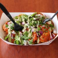 Curry Fries · Masala seasoned waffle fries topped with creamy curry sauce, red onions and fresh cilantro.