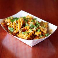 Garlic & Cilantro Fries · Crispy Waffle Fries Seasoned with Masala and Lemon tossed in Garlic & Cilantro. Served with ...