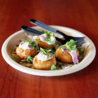 Aloo Tikki Bites (4pc) · Crispy potato patties topped with Red Onions, Mint Chutney & Fresh Cilantro.