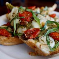 Pesto Mozzarella Crostini · Toasted bread, pesto, Italian cherry tomatoes, fresh mozzarella, fresh basil, roasted garlic...