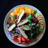 Chopped Cobb Salad · Breaded chicken, Roma tomatoes, bacon, eggs, red onions, cheddar, served with choice of dres...