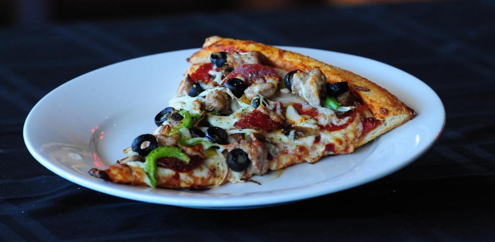 Extra Large New York Combo Pizza Slice · A slice of our New York combo pizza, with Italian sausage, pepperoni, meatballs, mixed bell peppers, mushrooms, onions, black olives and mozzarella cheese.
