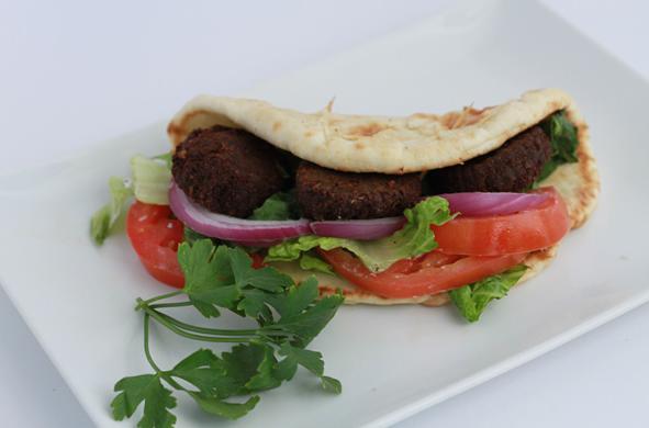 Falafel Sandwich · Vegetable patties. Fried patties made from ground chickpeas and spices served with lettuce, tomatoes, onions and our house sauce served on a tortilla wrap. Spicy. Veggie.
