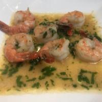 Camarones al Ajillo · sauteed Shrimp in garlic sauce served with rice and beans.
