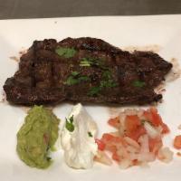 Carne Asada · Grilled skirt steak marinated in Mi Rancho's own signature sauce. Served with rice and beans.
