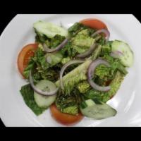 House Salad · Crisp romaine lettuce, cucumbers, tomatoes and red onions with red onions with our homemade ...