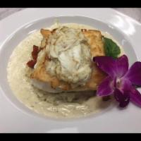 Halibut Ankinara · Flaky oven roasted halibut filet topped with lump crab meat, Camembert cheese and ratatouill...