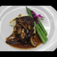 Filetto de Mignon · Tender grilled Angus beef fillet served over mashed potatoes, topped with a wild mushroom Ma...