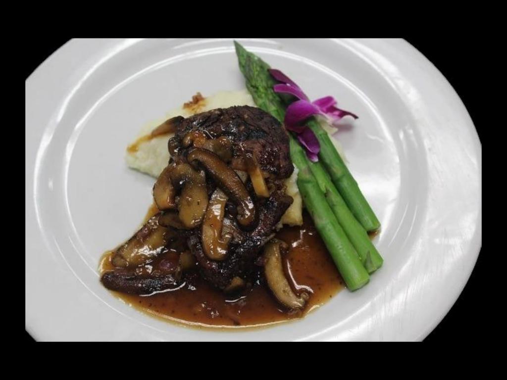 Filetto de Mignon · Tender grilled Angus beef fillet served over mashed potatoes, topped with a wild mushroom Marsala demi-glace and vegetable of the day.